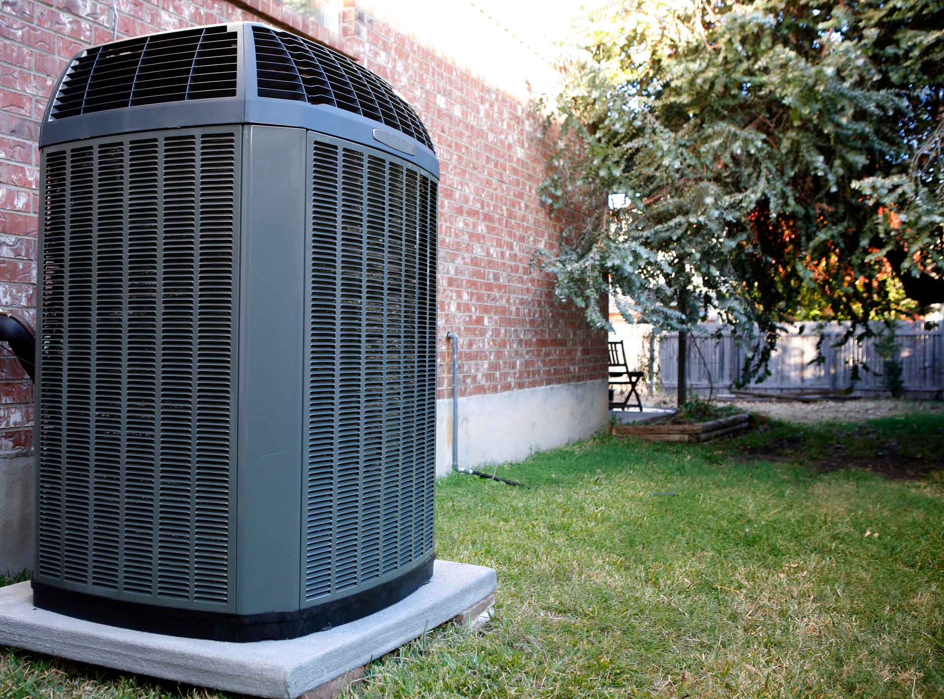 Modern heat pump/air conditioning system on exterior of house